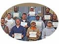 a group of men holding certificates