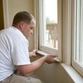 Carpenter repairing window frames