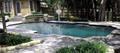 Straight line pool in Dallas with raised spa and tiered spillway
