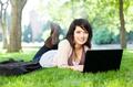 woman in grass with laptop