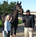 Deborah Powell standing with racehorse Zenyatta and Zenyatta's trainer, John Shirreffs