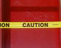 caution tape across red column