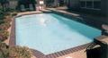 Straight line pool in Plano with brick coping and white plaster