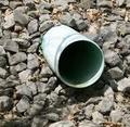 PVC drain pipe exit in rocks over natural drainage area