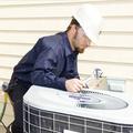 Air conditioning repairman working on a compressor unit