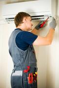 a man repair air conditioner 