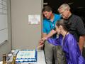 Atmospheric Science Data Center head John Kusterer and ANGe project managers Ronnie Gillian and Pam Rinsland cut the cake at the ANGe upgrade celebration hosted by SSAI. Photo Credit: NASA