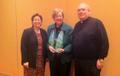 Dr. Maureen Gallagher accepts the 2014 Yves Congar Award from CPPCD's Msgr. James P. Lang and Terry Ginther