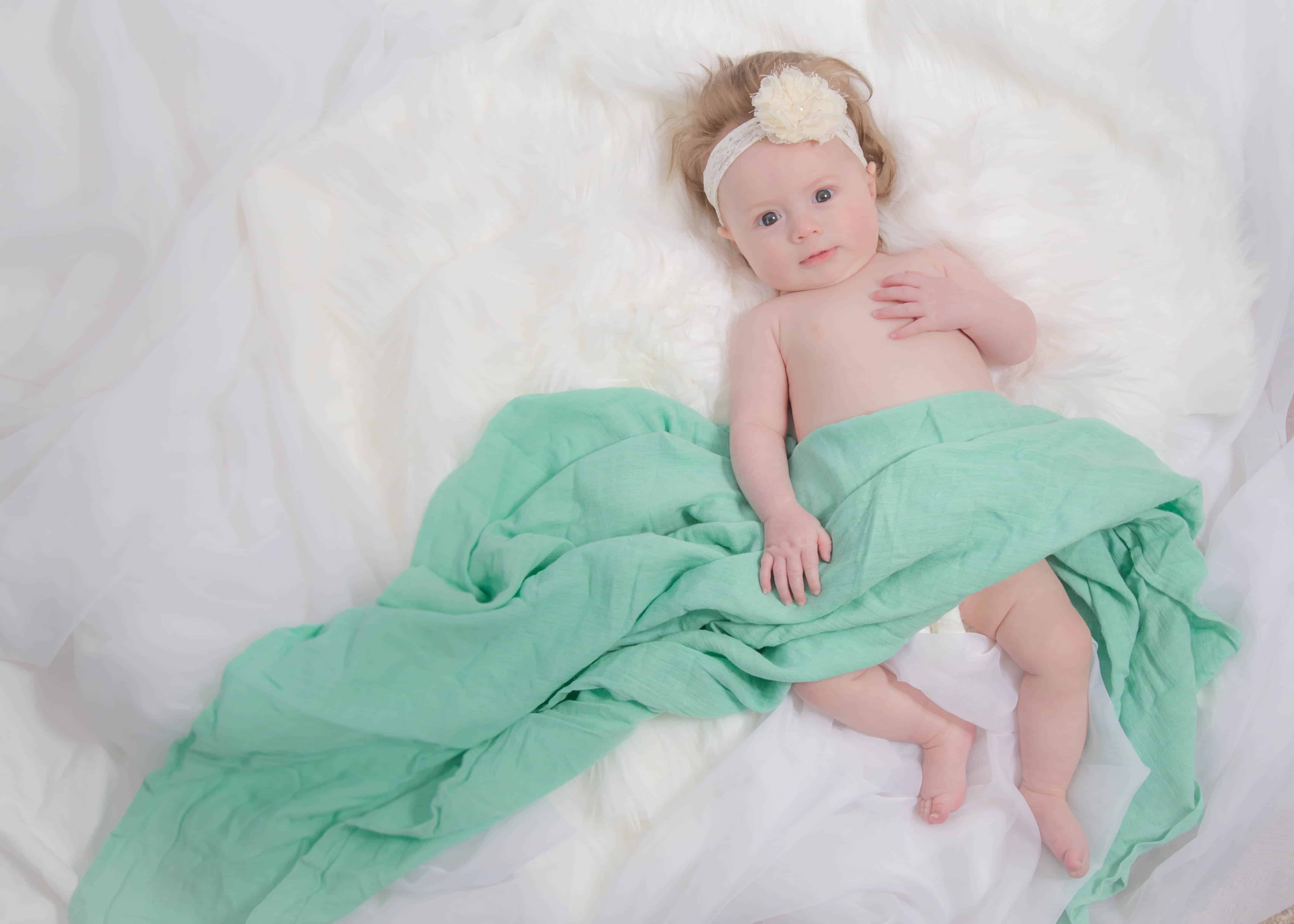 Baby girl Lauren 3 months photoshoot on bed in her home Michigan