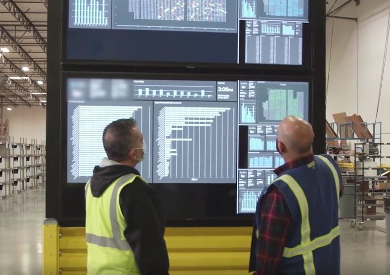 Workers reviewing automation dashboard