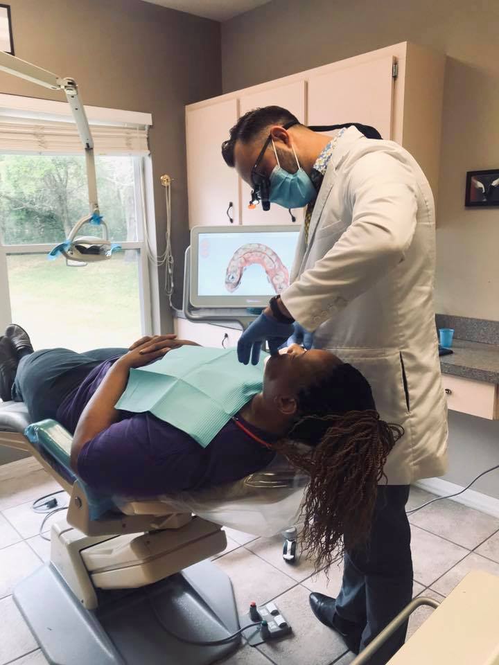 Tampa dentist Dr. Semeryuk works on dental crown using itero scanner at Tampa dentist Caroolwood Smiles